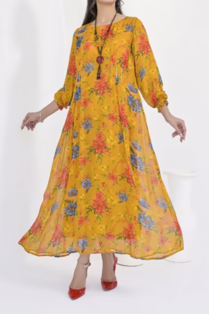 A vibrant yellow floral dress with orange and blue flower patterns, featuring a flowy design and long sleeves, styled with red shoes and a pendant necklace.