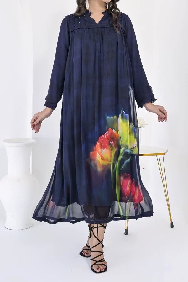 Elegant Navy Blue Maxi Dress with Bold Floral Print Navy blue maxi dress with long sleeves and bold floral prints at the hem, styled with strappy black sandals.