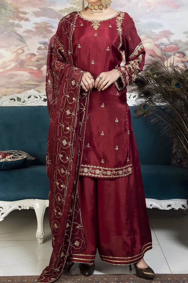 Elegant Maroon Embroidered Pakistani Party Wear Traditional Pakistani maroon dress with intricate golden embroidery, featuring a straight-cut shirt, wide-legged trousers, and a sheer embroidered dupatta.