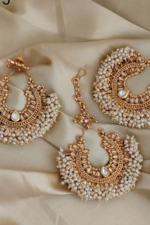 Gold Chandbali earrings with intricate design and pearl embellishments, perfect for traditional occasions.