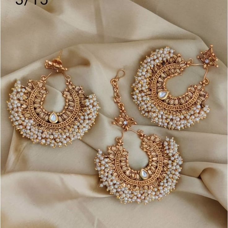 Gold-Plated Chandbali Earrings with Pearl Detailing – Perfect for Traditional Occasions. Gold Chandbali earrings with intricate design and pearl embellishments, perfect for traditional occasions.
