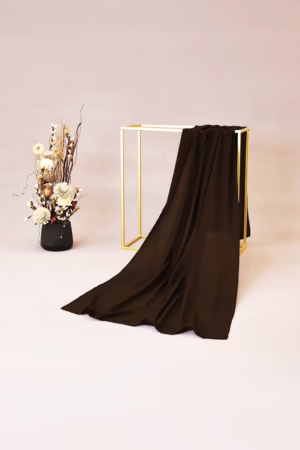 Lightweight brown chiffon hijab with a soft and flowy texture, ideal for versatile and elegant styling.