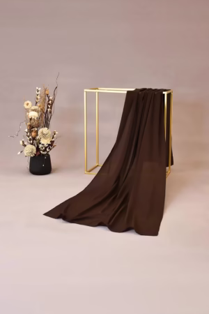 Lightweight chocolate chiffon hijab with a soft and flowy texture, ideal for versatile and elegant looks.