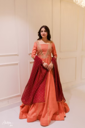 Solid peach hand-embellished Anarkali dress with delicate embroidery, paired with a matching dupatta, perfect for weddings and special occasions.