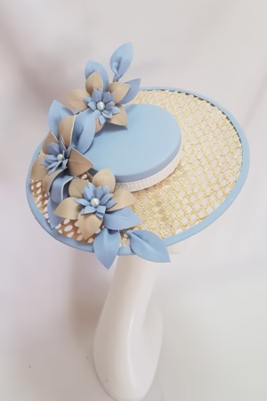Elegant blue fascinator hat with intricate floral details and a chic design, perfect for special occasions like weddings or garden parties.