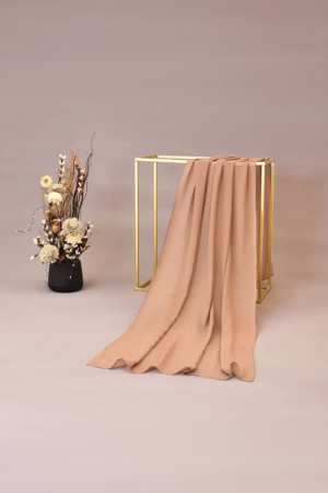 Lightweight sand peach chiffon hijab with a smooth and elegant drape, ideal for both casual and formal wear.
