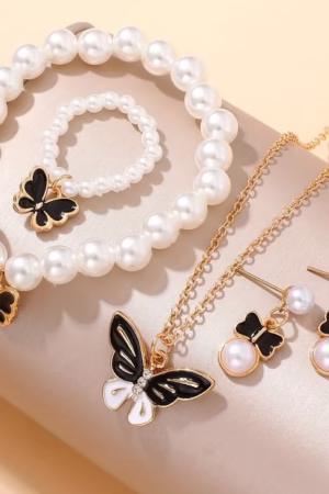 Butterfly-themed pearl jewelry set with necklace, earrings, bracelet, and ring.
