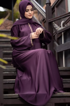 A Raisin Purple Abaya displayed gracefully on a mannequin, showcasing its deep, luxurious color and flowing fabric.