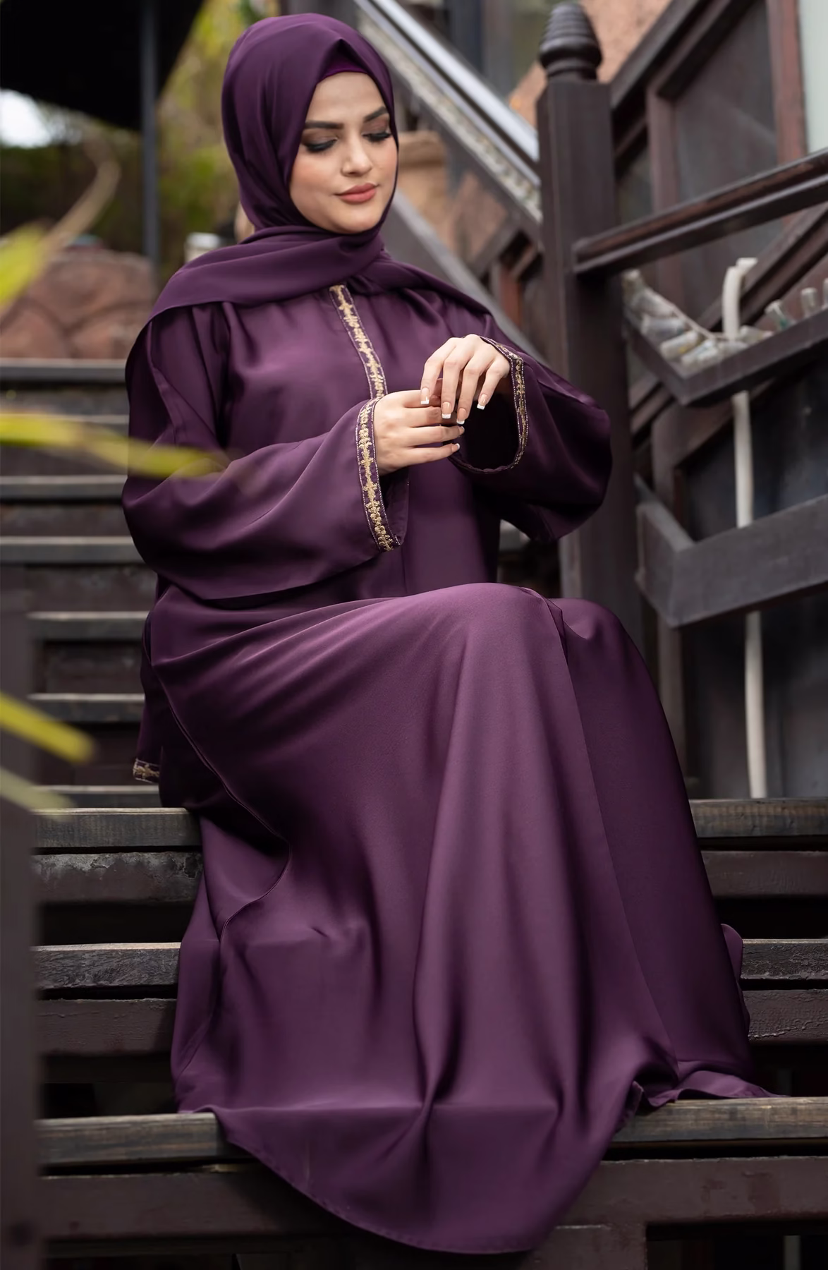 Raisin Purple Abaya: A Blend of Elegance and Everyday Comfort A Raisin Purple Abaya displayed gracefully on a mannequin, showcasing its deep, luxurious color and flowing fabric.