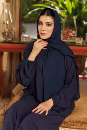 A Loop Button Blue Abaya displayed on a mannequin, showcasing its delicate button details and flowing, soft fabric.