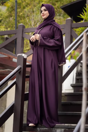A Raisin Purple Abaya displayed gracefully on a mannequin, showcasing its deep, luxurious color and flowing fabric.