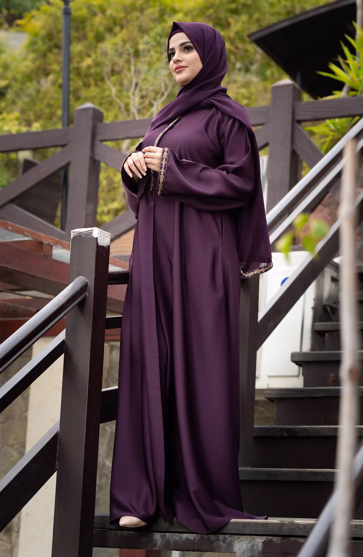 Raisin Purple Abaya: A Blend of Elegance and Everyday Comfort A Raisin Purple Abaya displayed gracefully on a mannequin, showcasing its deep, luxurious color and flowing fabric.